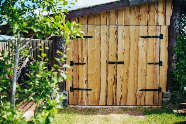Rural-style unedged board barn gate - rough lumber processing - forged hinges and deadbolt
