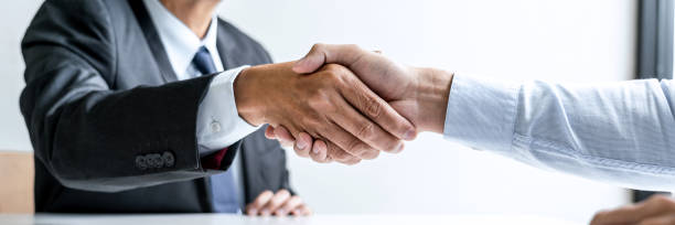 istock Greeting new colleagues, Handshake while job interviewing, male candidate shaking hands with Interviewer or employer after a job interview, employment and recruitment concept 1254602526