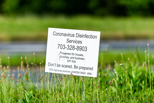 Culpeper, USA - June 9, 2020: Sign on road street for coronavirus disinfection services with phone number and information for treatment of houses