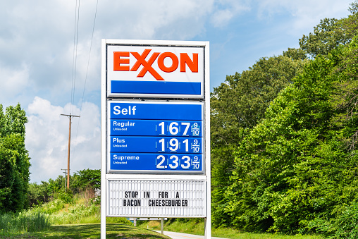 Roseland, USA - June 9, 2020: Famous scenic road route 151 Patrick Henry highway in Nelson County, Virginia with exxon gas station sign and cheap prices with bacon cheeseburger