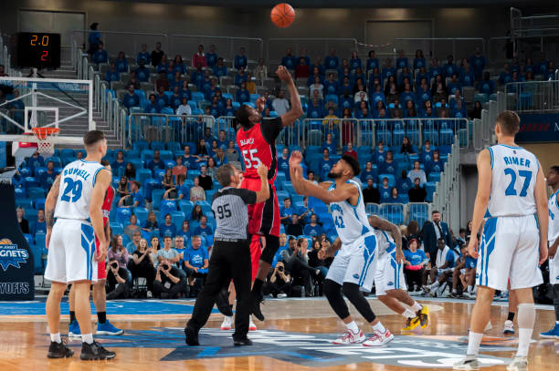 istock Basketball players chasing for ball 1254607330