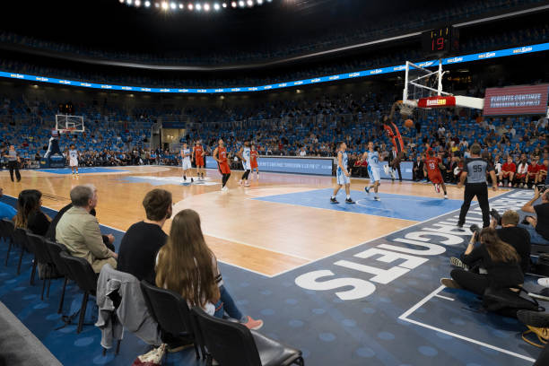 istock Basketball player scoring slam dunk 1254607386