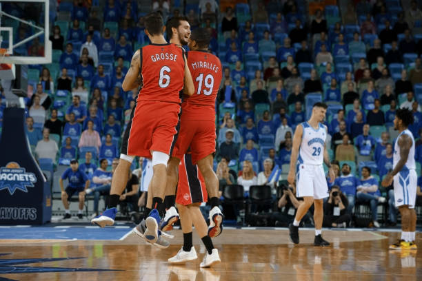 istock Basketball players celebrating 1254607596