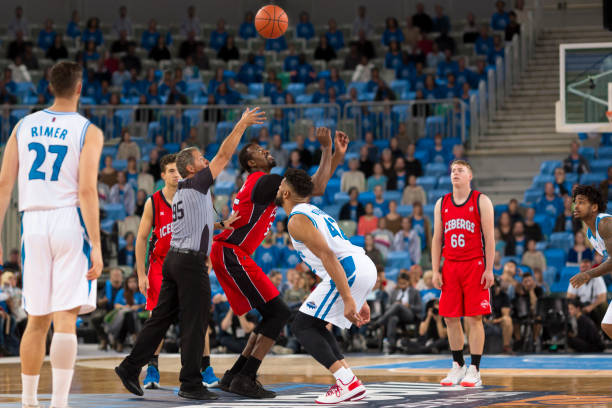 istock Basketball players chasing for ball 1254608226