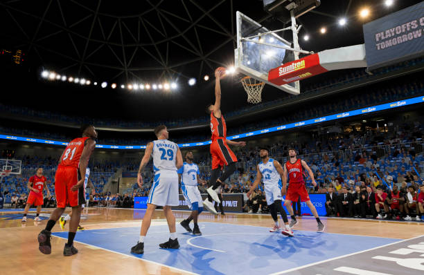 istock Basketball player slam dunking ball 1254608542