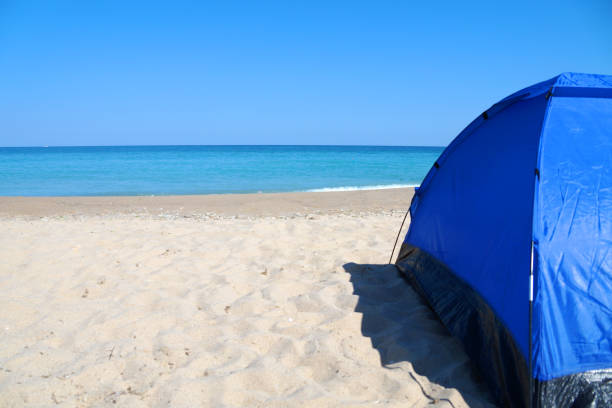 istock blue tourist tent on an empty sandy beach by the sea 1254609093