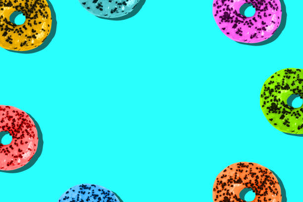 istock Donuts are colored on a bright background with a copy of the space. Unhealthy diet. Minimum summer template 1254612090