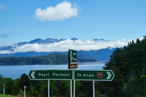 Highway 95 roadsign - Pearl Harbour - Te Anau - Lake Manapouri in background