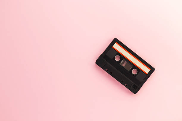 istock Retro audio tape cassette from 80s and 90s isolated on pink background. Old technology concept. Flat lay, top view with copy space. 1254612759