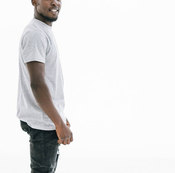 istock side view. confident young man in white t-shirt looking at came 1254614782