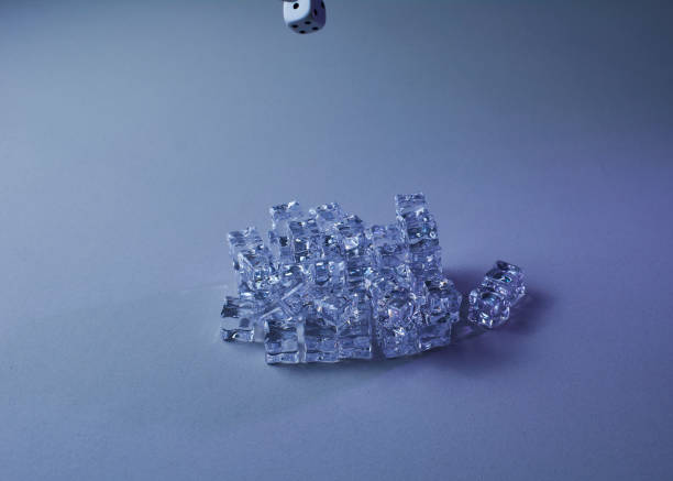 istock Set of ice cubes and dice falling on them. 1254615408