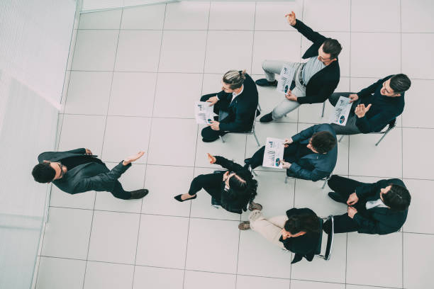 istock top view. Manager asks questions during a business meeting 1254617944