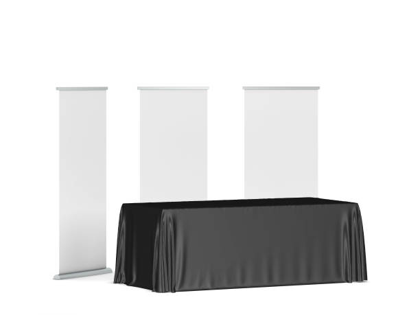istock Blank tradeshow tablecloth with roll-up banners aside 1254620799