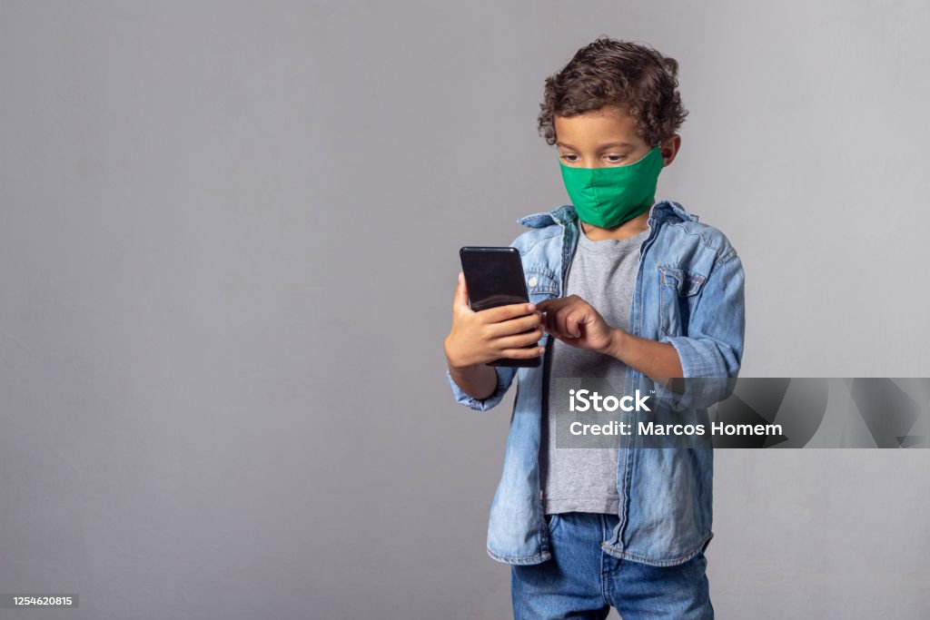 White Boy With Curly Hair Wearing Protective Mask Against Covid19 With Smartphone Stock Photo - Download Image Now - iStock White Boy With Curly Hair Wearing Protective Mask Against Covid19 With Smartphone Stock Photo - Download Image Now - iStock