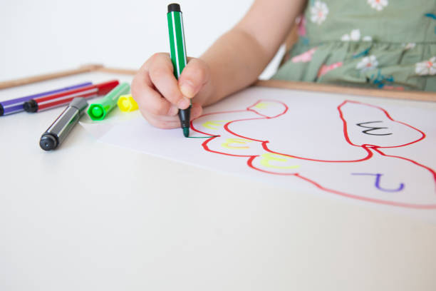 istock Little girl drawing on white paper 1254621421