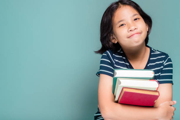 istock Child Holding Books 1254623486