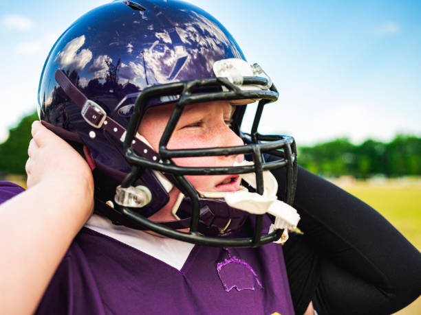 istock Junior Football player getting helmet ready 1254623773