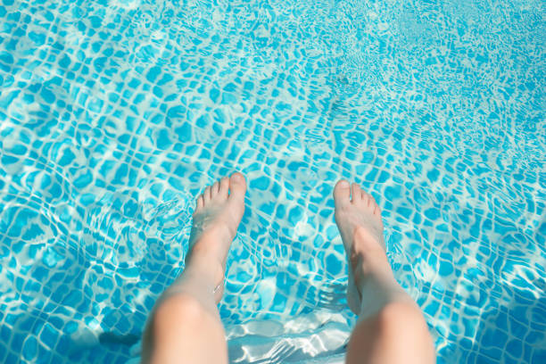 istock Kid boy feet at the pool. View from the top. 1254624205