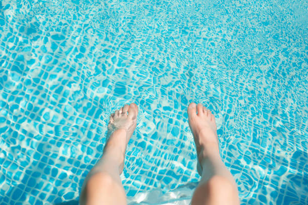 istock Kid boy feet at the pool. View from the top. 1254624210