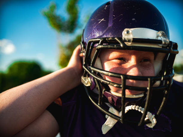istock Junior Football player getting helmet ready 1254625469