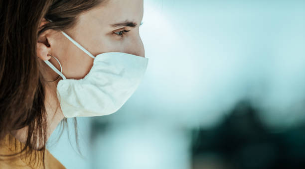 istock close up. a young woman in a protective mask 1254626187