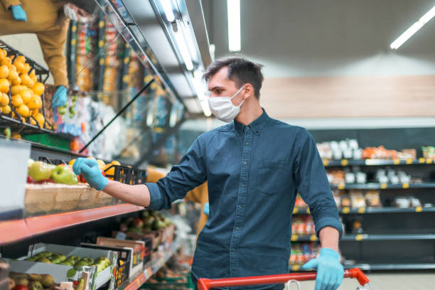 istock customer in a protective mask filling a shopping cart 1254626513