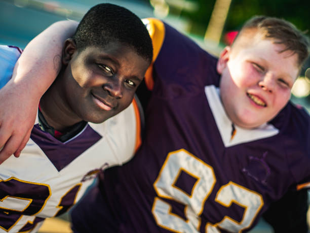 istock Junior Football players goofing after practice 1254626536