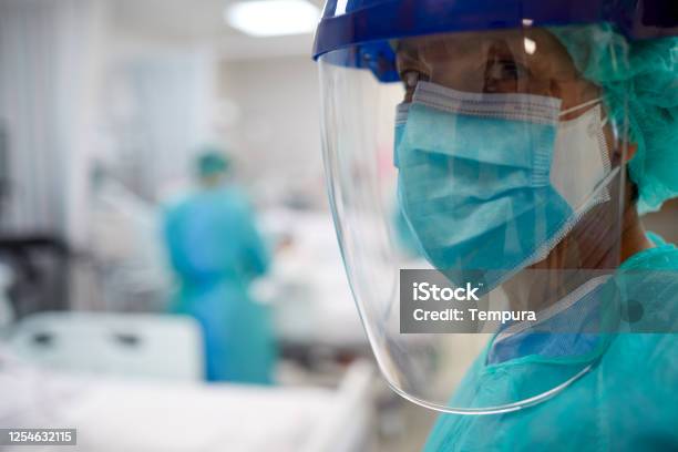 Close Up View Of A Doctor Wearing Surgical Mask And A Face Shield Stock Photo - Download Image Now