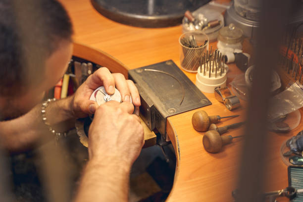 istock Man leaning over the engraving block ball vise 1254632272
