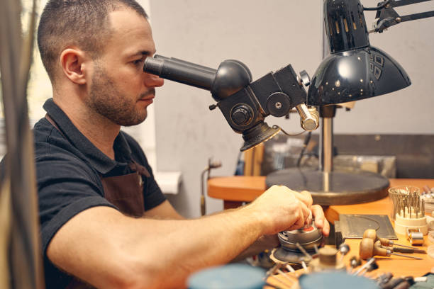 istock Serious male jeweler using an optical tool 1254632288