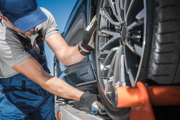 istock Towing Truck Worker Preparing For Car Shipment 1254633374