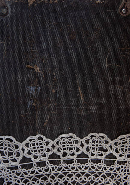 istock Old vintage lace fabric on rustic material background 1254634178