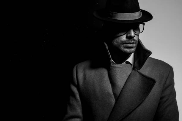 istock attractive elegant man in long coat looking to side 1254634184