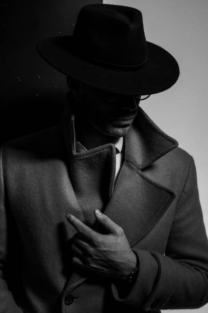 istock dramatic elegant man holding finger in a fashion pose 1254634291