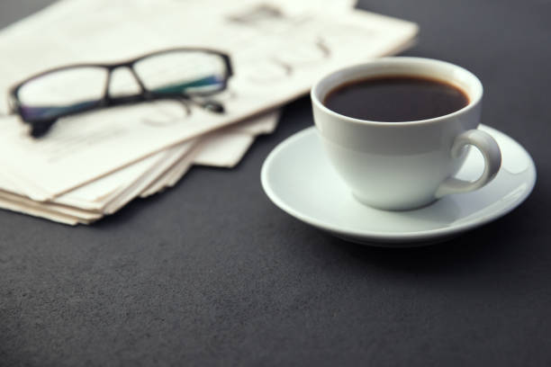 istock glasses on newspapers with coffee 1254634326