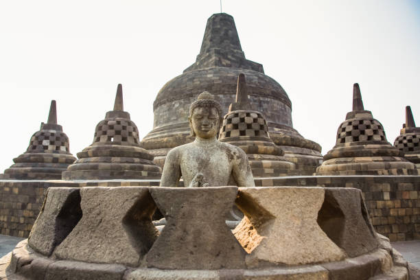 istock Buddha statue in the world's largest Buddhist Temple Borobudur taken at Sunset Yogyakarta, Java Island,Indonesia 1254637507