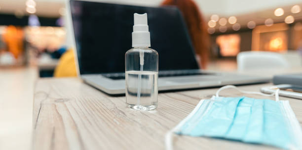 istock close up. spray and protective mask on the office Desk 1254639473