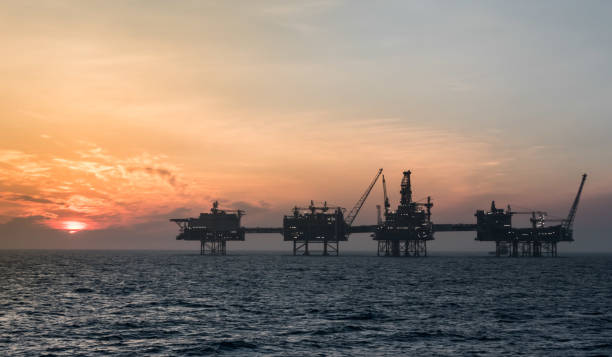 sunset offshore north sea - oil rig construction platform oil industry sea imagens e fotografias de stock