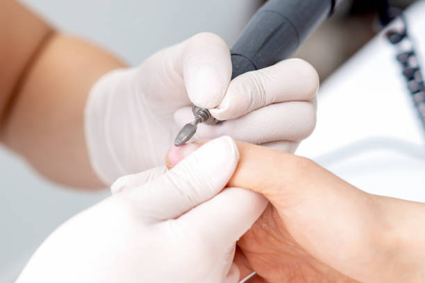istock Manicure master uses an electric nail machine 1254642020