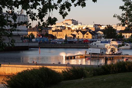 Oulu, Finland - June 2020: Port, lakeside with private boats at sunset. Warm evening sunlight