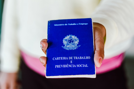 July 4, 2020, Brazil. Woman holds his Brazilian document work and social security (Carteira de Trabalho e Previdencia Social).