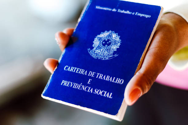 istock Woman holds his Brazilian document work and social security (Carteira de Trabalho e Previdencia Social) 1254643658