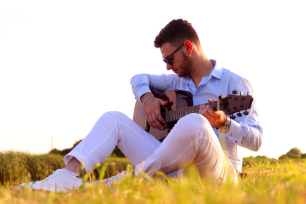 istock Romantic young man playing an acoustic guitar 1254644155