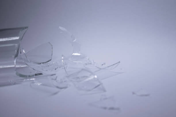istock pieces of broken glass are scattered on a gray-white background 1254644285