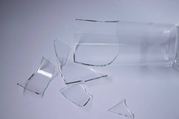 istock fragments of a broken glass in a broken glass on a white background. Isolated. Copy space 1254644563