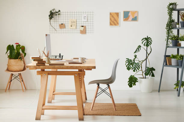 istock Eco home office with wooden table, various potted plants and modern computer 1254646153