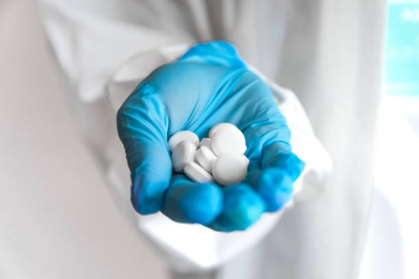istock doctor holding a pills. Isolated on white background 1254648502