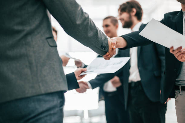 group of employees shaking hands at an office meeting close up. a group of employees shaking hands at an office meeting. business concept general manager stock pictures, royalty-free photos & images