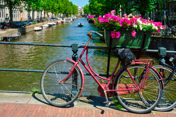 istock Amsterdam canal with boats and bicycles on a bridge 1254659186