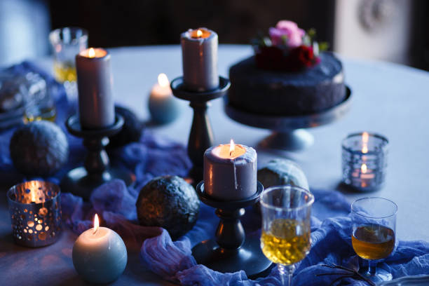 istock Romantic table setting in gray style on the table: burning candles, plates, vintage silverware, linen napkin, gray textile. 1254661263